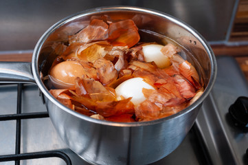 Boiling onion peels together with eggs will disolve natural earthy and organic colour and dye the eggs.