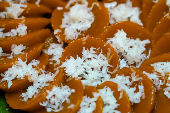 Closeup view of homemade Filipino dish Kutsinta with coconut flakes