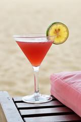  Red cocktail on tropical sandy beach        