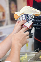 customer receiving cheeseburger in fast food place