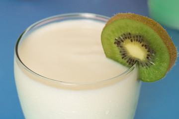 close-up photo of yogurt with kiwi on blue background