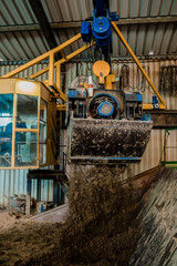 Plant for the production of bricks from clay. Plant for production building material with ready brick, construction industrial. Production of bricks on plant. Workflow, close-up. Many bricks