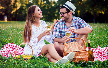 Loving couple enjoying picnic in the park. Love and tenderness, dating, romance, lifestyle concept