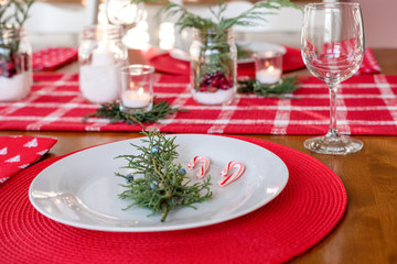 Low angel closeup of holiday dinner table decorated in red and white