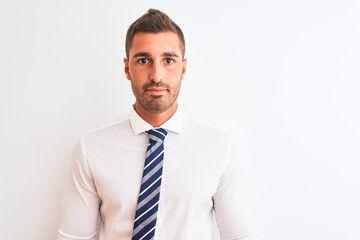 Young handsome elegant business man over isolated background Relaxed with serious expression on face. Simple and natural looking at the camera.