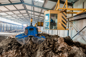 Plant for the production of bricks from clay. Plant for production building material with ready brick, construction industrial. Production of bricks on plant. Workflow, close-up. Many bricks