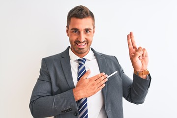 Young handsome business man wearing suit and tie over isolated background smiling swearing with...