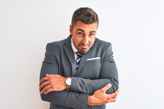 Young Handsome Business Man Wearing Suit And Tie Over Isolated Background Shaking And Freezing For Winter Cold With Sad And Shock Expression On Face