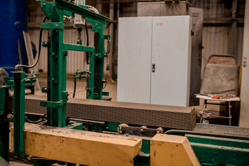 Plant for the production of bricks from clay. Plant for production building material with ready brick, construction industrial. Production of bricks on plant. Workflow, close-up. Many bricks