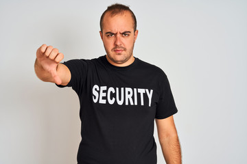 Young safeguard man wearing security uniform standing over isolated white background with angry...