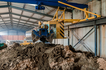 Fototapeta premium Clay for bricks. Plant for production building material with ready brick, construction industrial. Production of bricks on plant. Workflow, close-up.