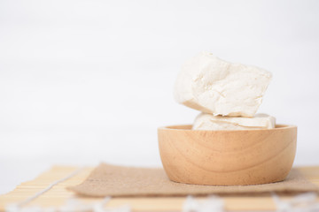 Fototapeta na wymiar Fresh tofu in brown wooden bowl on a white background