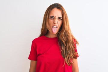 Young redhead woman wearing red casual t-shirt stading over white isolated background sticking...