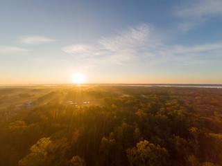Colorful Sunrise over Forest and Countryside. Aerial Drone View