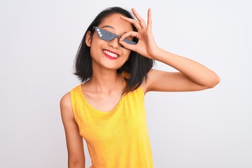 Young beautiful chinese woman wearing thug life sunglasses over isolated white background doing ok...