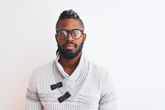 African american man wearing grey sweater and glasses over isolated white background with serious expression on face. Simple and natural looking at the camera.