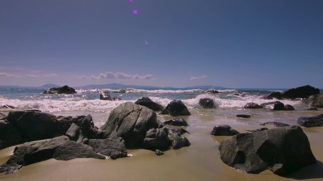 Waves lapping against rocks on a beach