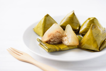 Thai dessert (Khanom Tian), sweet stuffed dough pyramid wrapped by banana leaf
