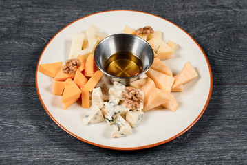 nuts and cheese set with honey close up food for restaurant menu