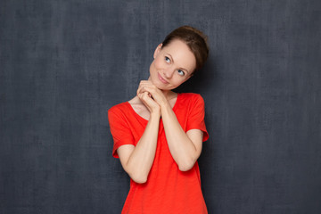 Portrait of happy woman smiling and dreaming about something pleasant