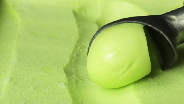 Closeup Hands Scooping ice cream flavor lemon, Food concept.