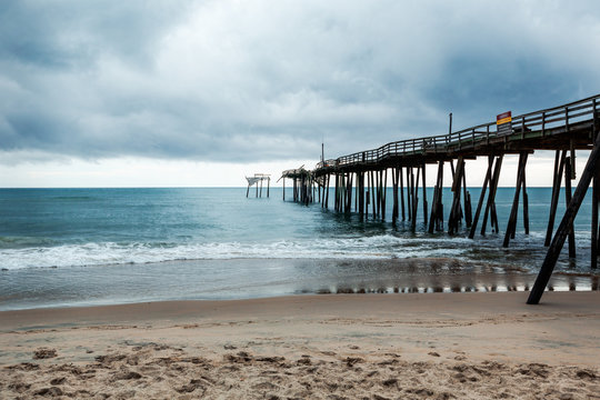 Old Fishing Pier In Frisco North Carolina Outer Banks Left In Ruins After A Hurricane. Pier Is Destroyed And Falling Apart