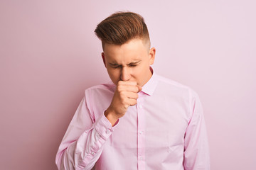 Young handsome businessman wearing elegant shirt standing over isolated pink background feeling...