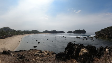 View of beach with beautiful coral, nice waves, and beautiful blue sky