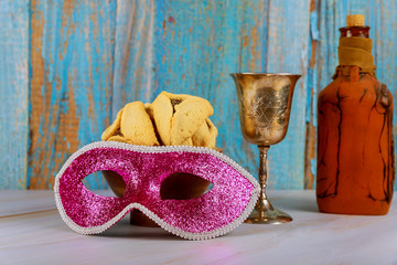 Hamans ears cookies noisemaker and mask for Purim celebration jewish carnival holiday