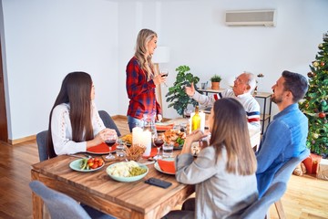 Beautiful family meeting smiling happy and confident. Speaking speech eating roasted turkey celebrating Christmas at home