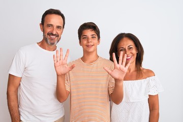 Family of three, mother, father and son standing over white isolated background showing and pointing up with fingers number ten while smiling confident and happy.