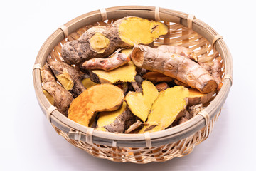 Dried close up Turmeric and Cassumunar ginger roots with slices in a basket isolate on white background.(Curcuma longa Linn)