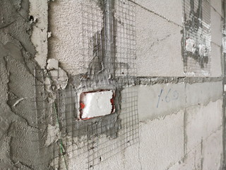 Installation of electrical wiring on the wall. Work plaster on masonry.
