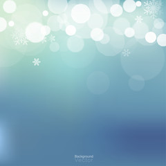 White bokeh and snowflakes on light blue background