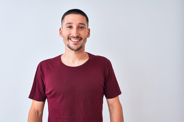 Young handsome man standing over isolated background with a happy and cool smile on face. Lucky person.