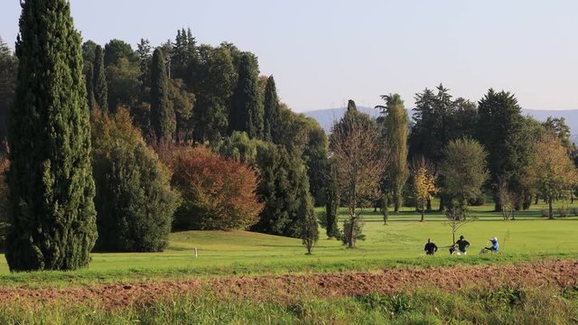 Friends walking in a Golf Club Park