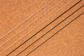 Classical guitar strings on balsa wood texture background