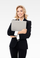 Naklejka premium Portrait of young happy smiling businesswoman in black confident suit, with grey folder, with copy space for slogan or text, isolated over grey background
