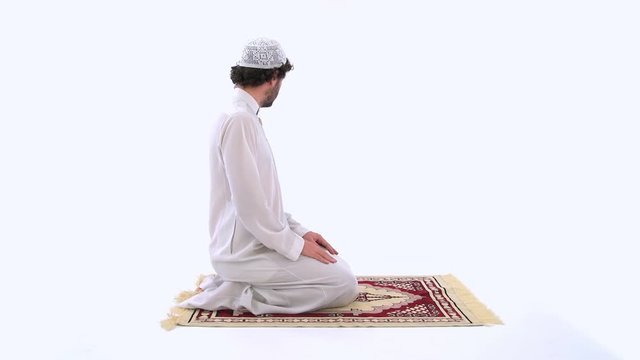 Muslim Arabian Man Performing the Taslim in Salah, White Background