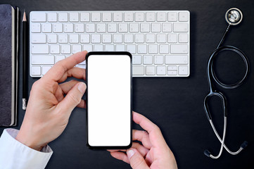 Top view doctor hand holding smartphone with blank screen