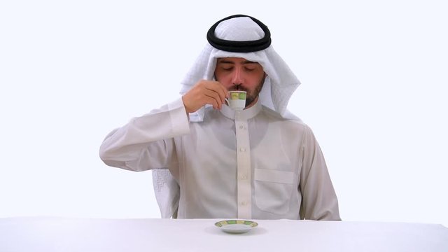 Saudi Arabian Man Drinking Arabic Coffee in White Background Studio