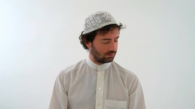 Muslim Arabian Man Performing the Taslim and Praying, White Background
