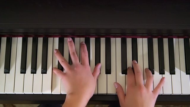 Close Up Young Female Pianist Hands Playing Piano Top View