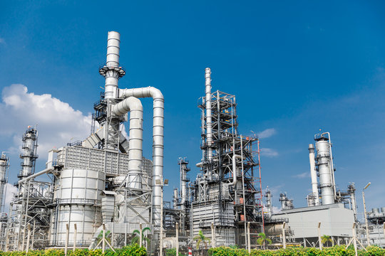 Oil and gas industrial,Oil refinery plant form industry,Refinery factory oil storage tank and pipeline steel blue sky background