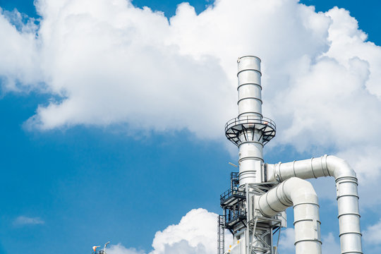 Oil and gas industrial,Oil refinery plant form industry,Refinery factory oil storage tank and pipeline steel blue sky background