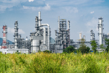 Oil and gas industrial,Oil refinery plant form industry,Refinery factory oil storage tank and pipeline steel blue sky background