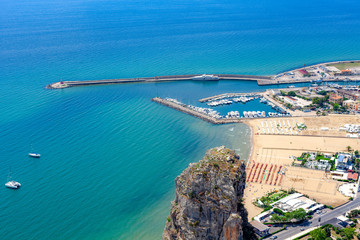 Top view to blue sea, the Terracina port, Pisco Montano rock and beach on a bright sunny day. Terracina, Province of Latina, Lazio, Italy.