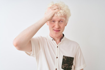 Young albino blond man wearing casual shirt standing over isolated white background stressed with...