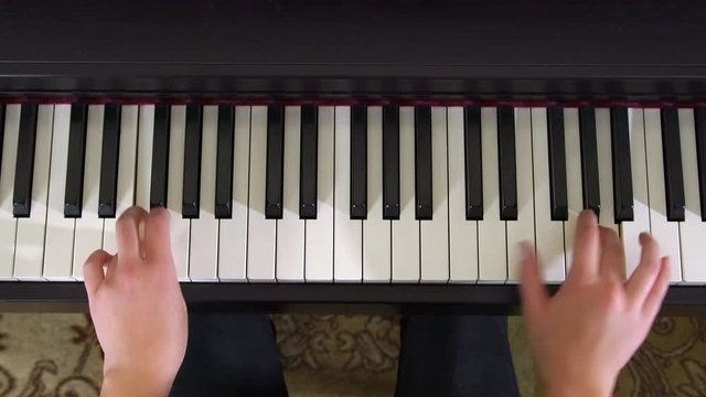 Caucasian Young Female Pianist Hands Playing Piano Top View