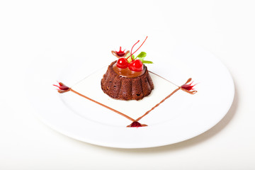 Chocolate cake with topping and preserved cherry